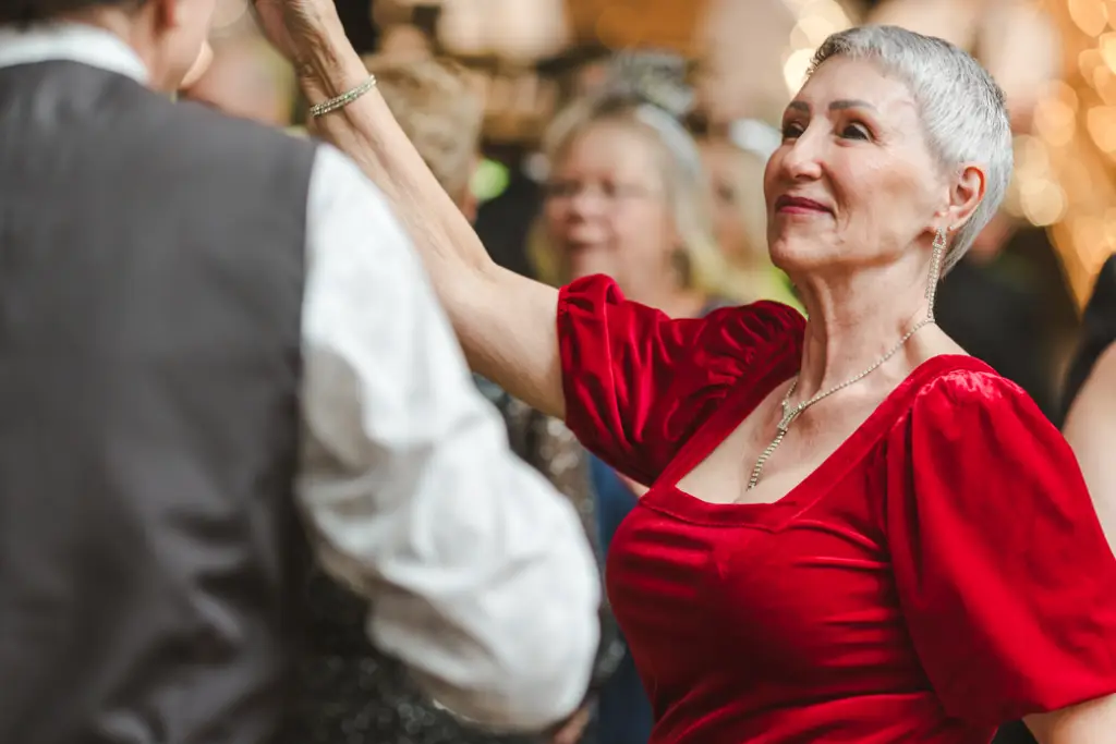 Lady in red dancing with partner at Carmens New Year's Eve Party